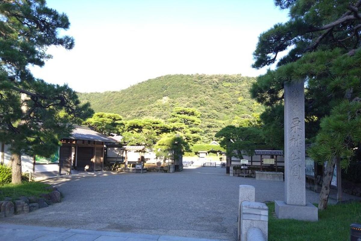 a street with a building and a mountain in the background
