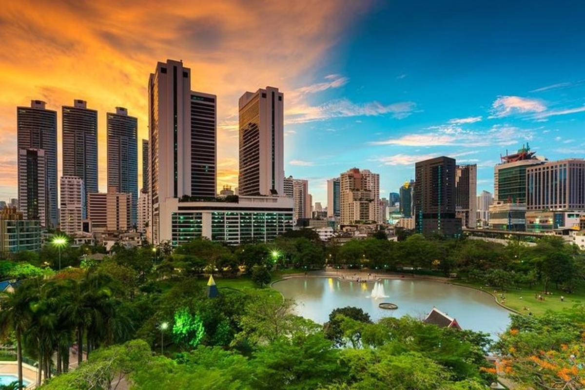 a city skyline with a pond in front of a city
