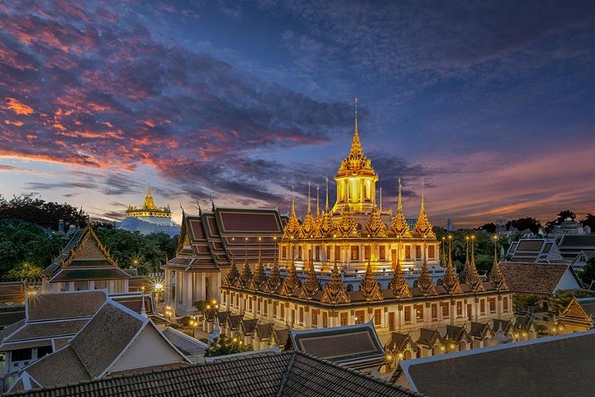 a lit up building at night with a sunset
