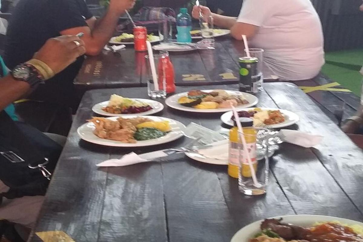 un gruppo di persone sedute a un tavolo con piatti di cibo