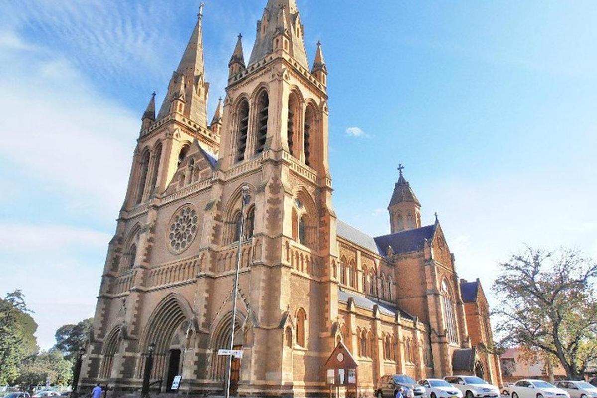 a large church with cars parked in front of it