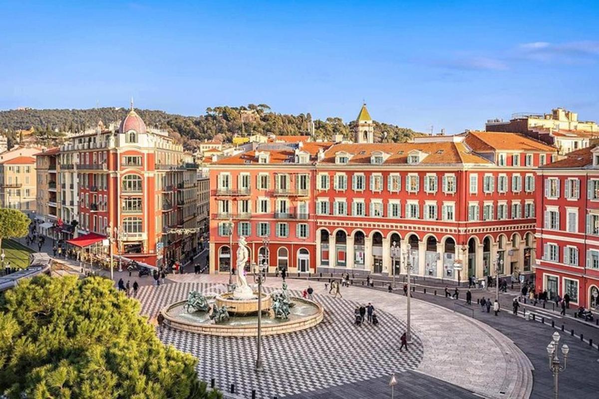 a city square with a fountain in front of buildings