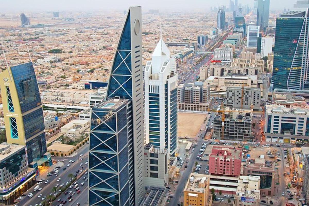 an aerial view of a city with a tall building