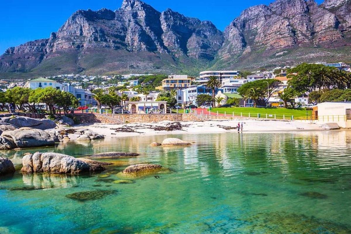 a body of water with a beach and mountains