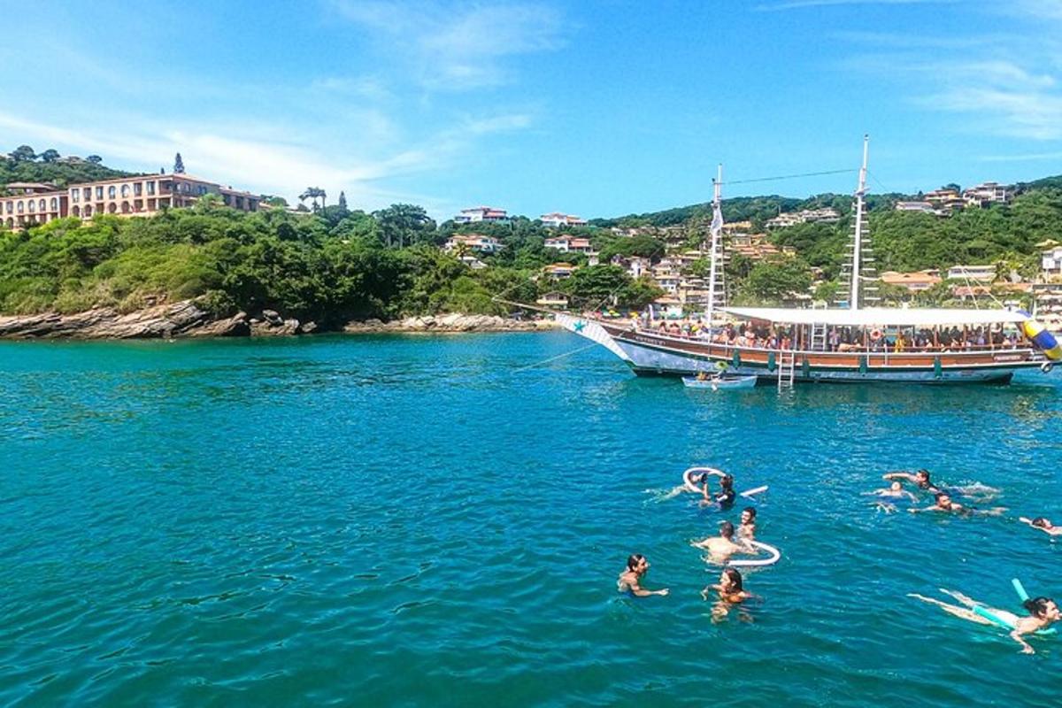 a group of people swimming in the water near a boat