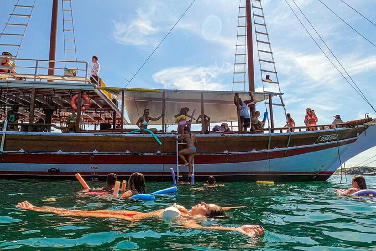 a group of people in the water in front of a boat