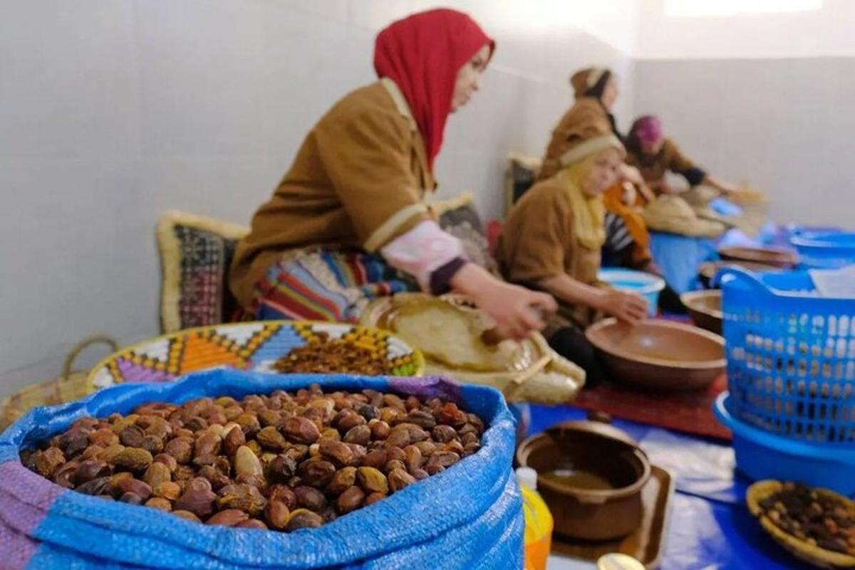 a group of people sitting around a table with food