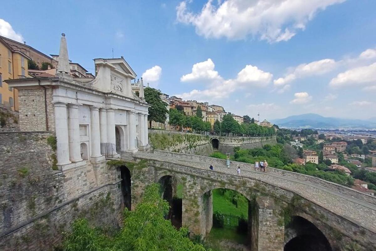 an old bridge with people walking on top of it