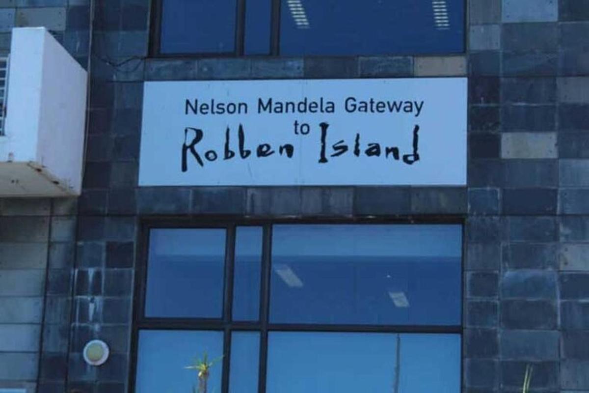 a sign on a building that says nelson mandela gateway to ribbon island