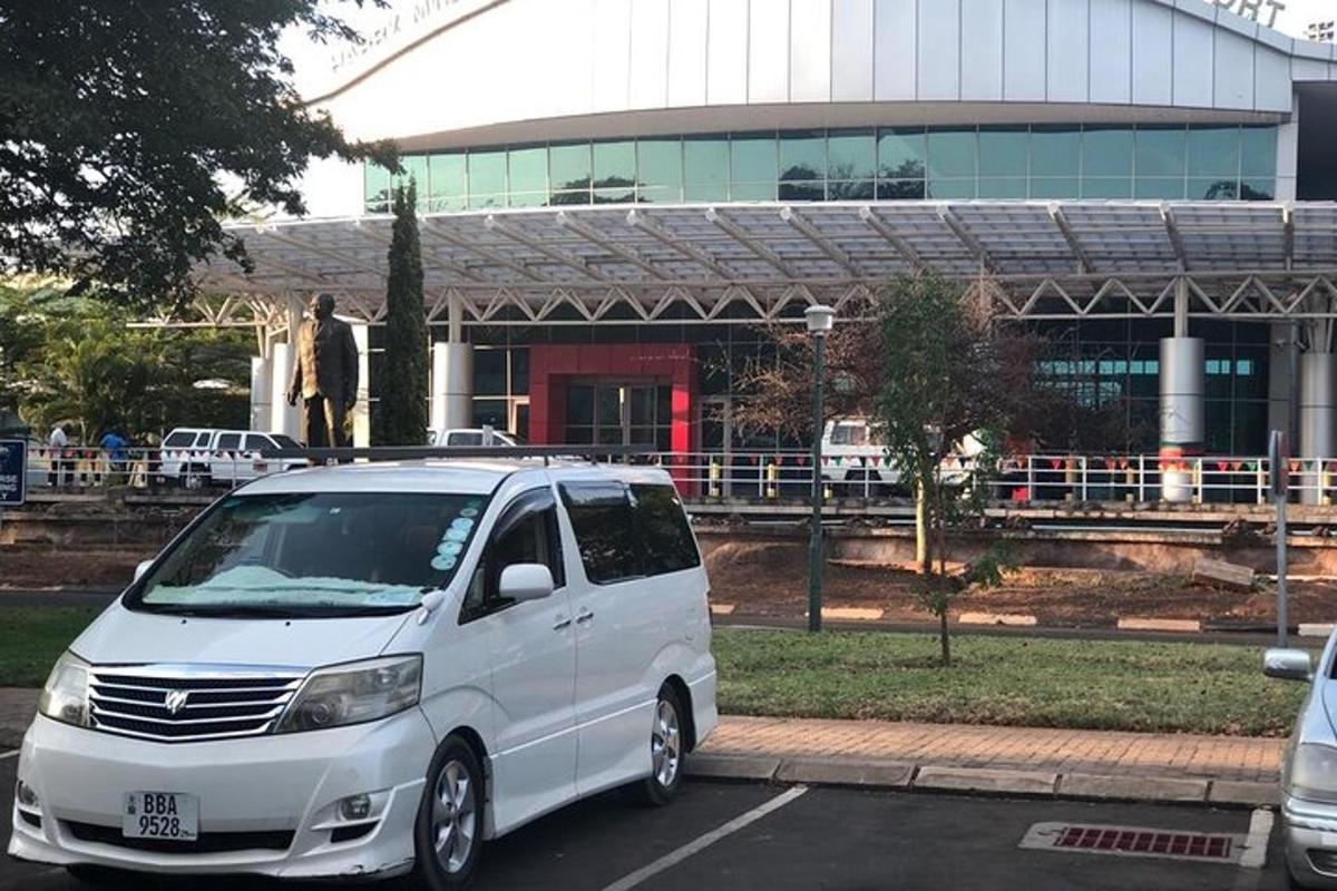 a white van parked in a parking lot in front of a building