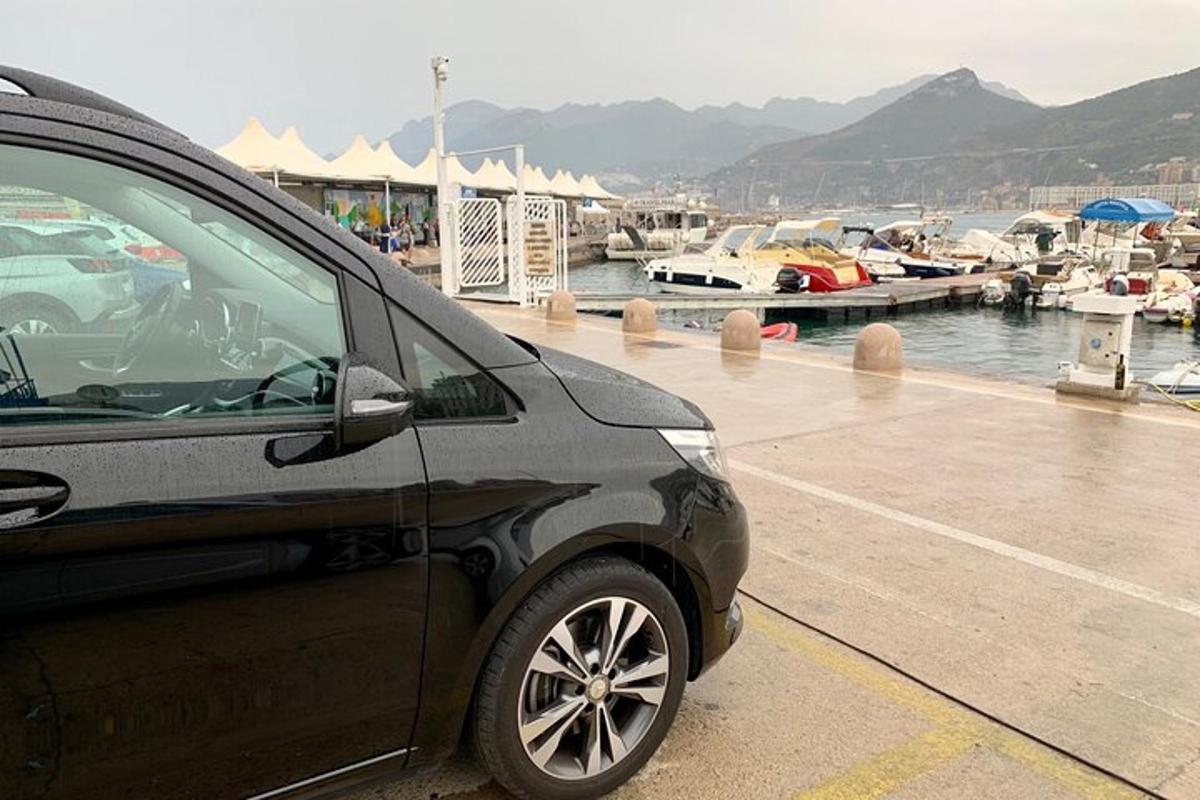 a car parked next to a marina with boats
