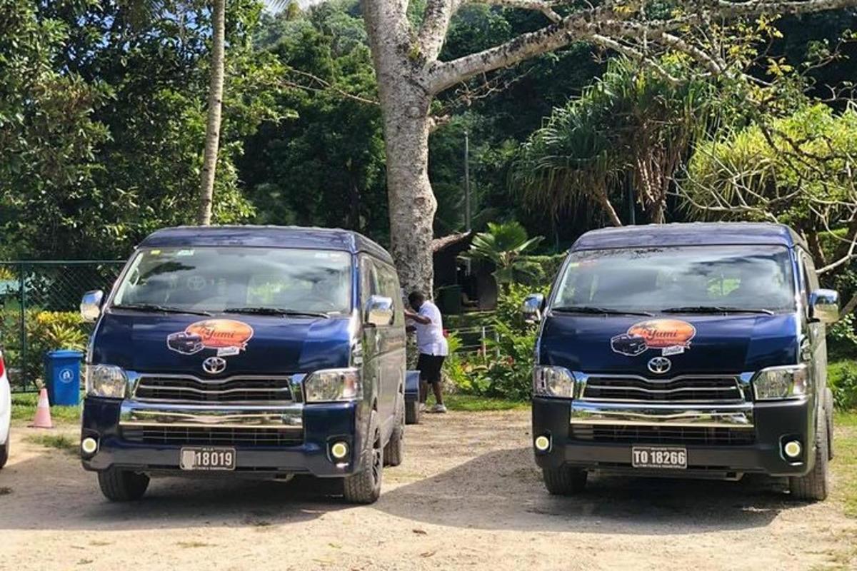 two blue trucks parked next to each other
