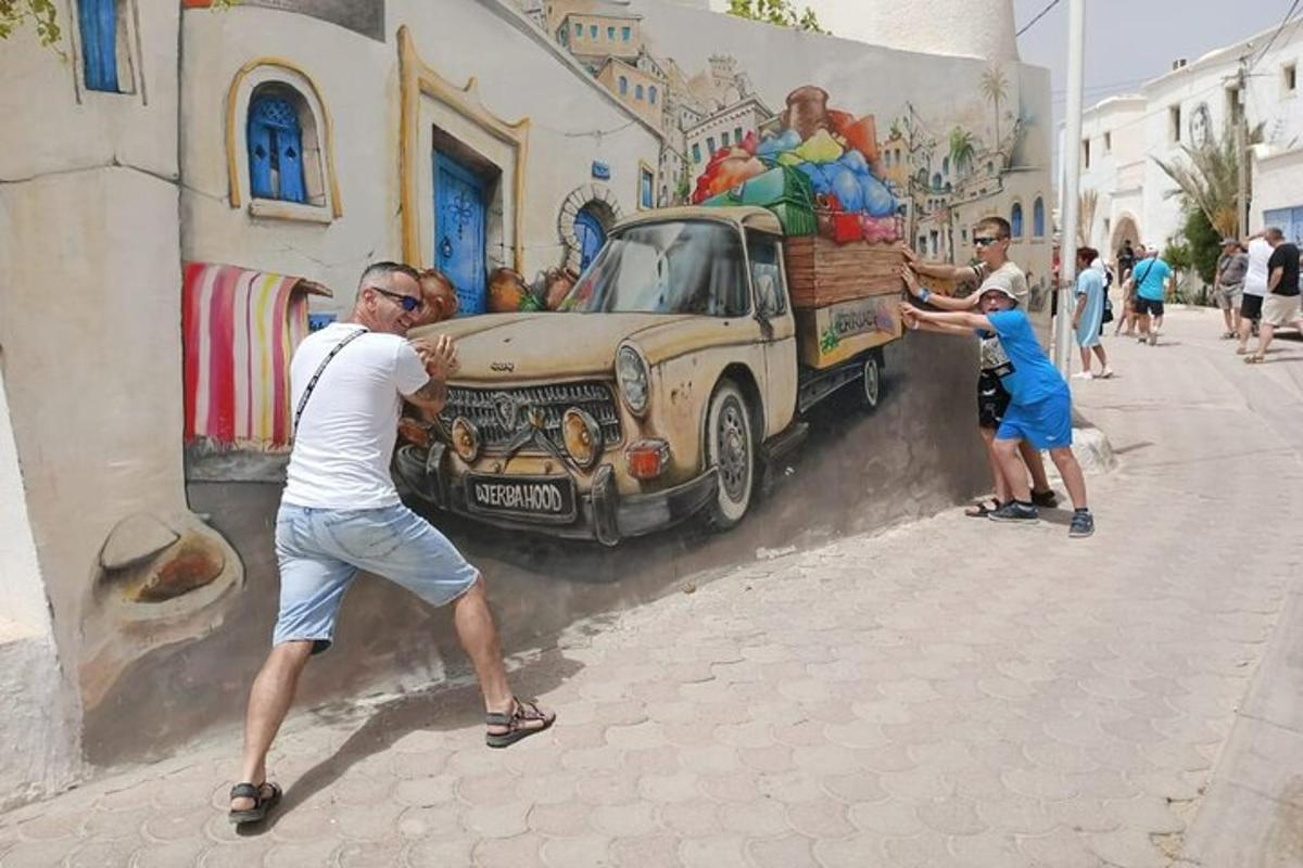 a man painting a painting of a truck on a wall