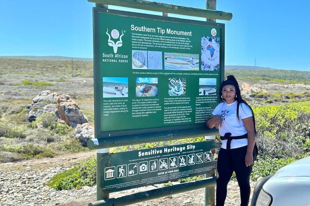 a woman standing next to a sign in the desert