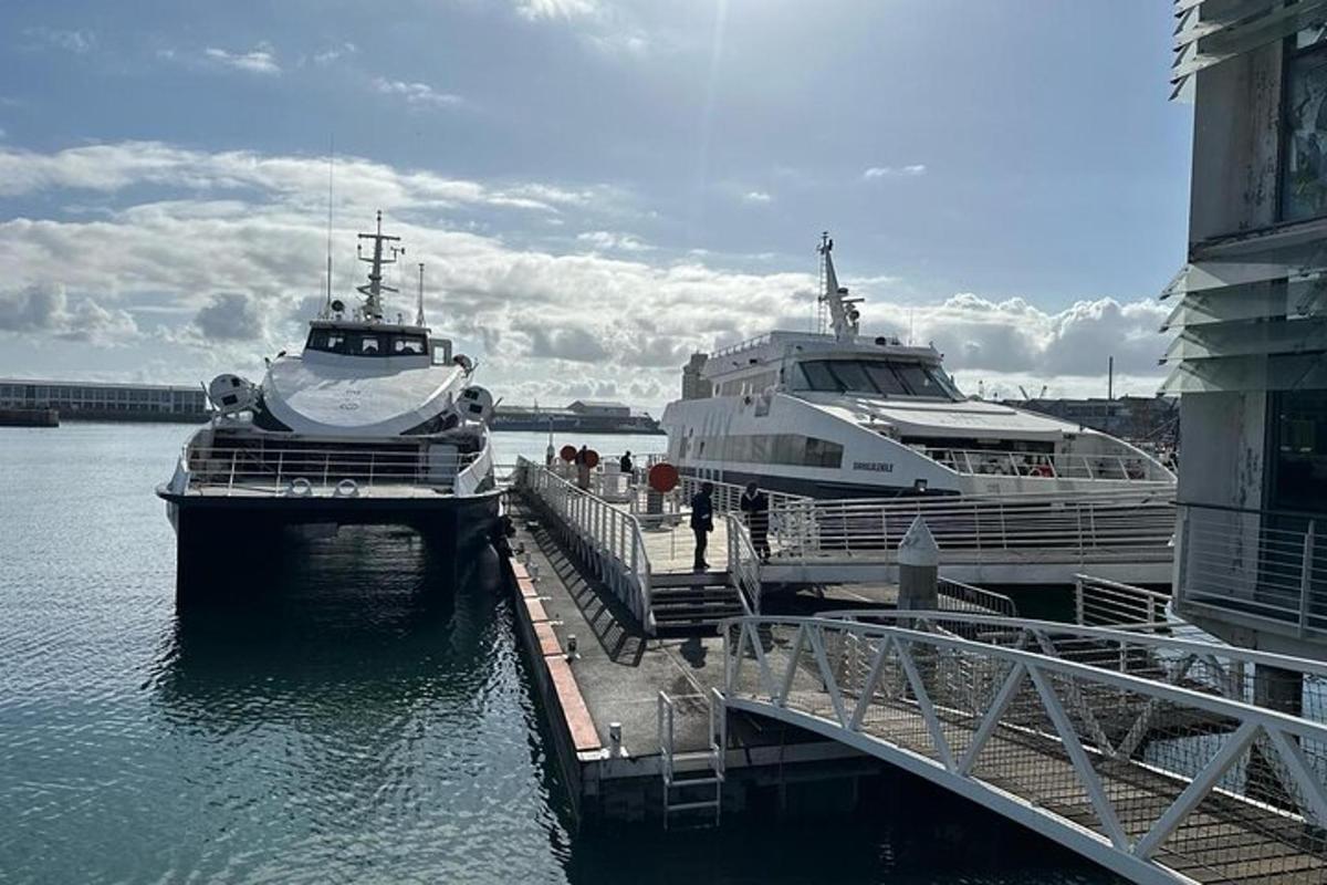 two boats are docked at a dock in the water