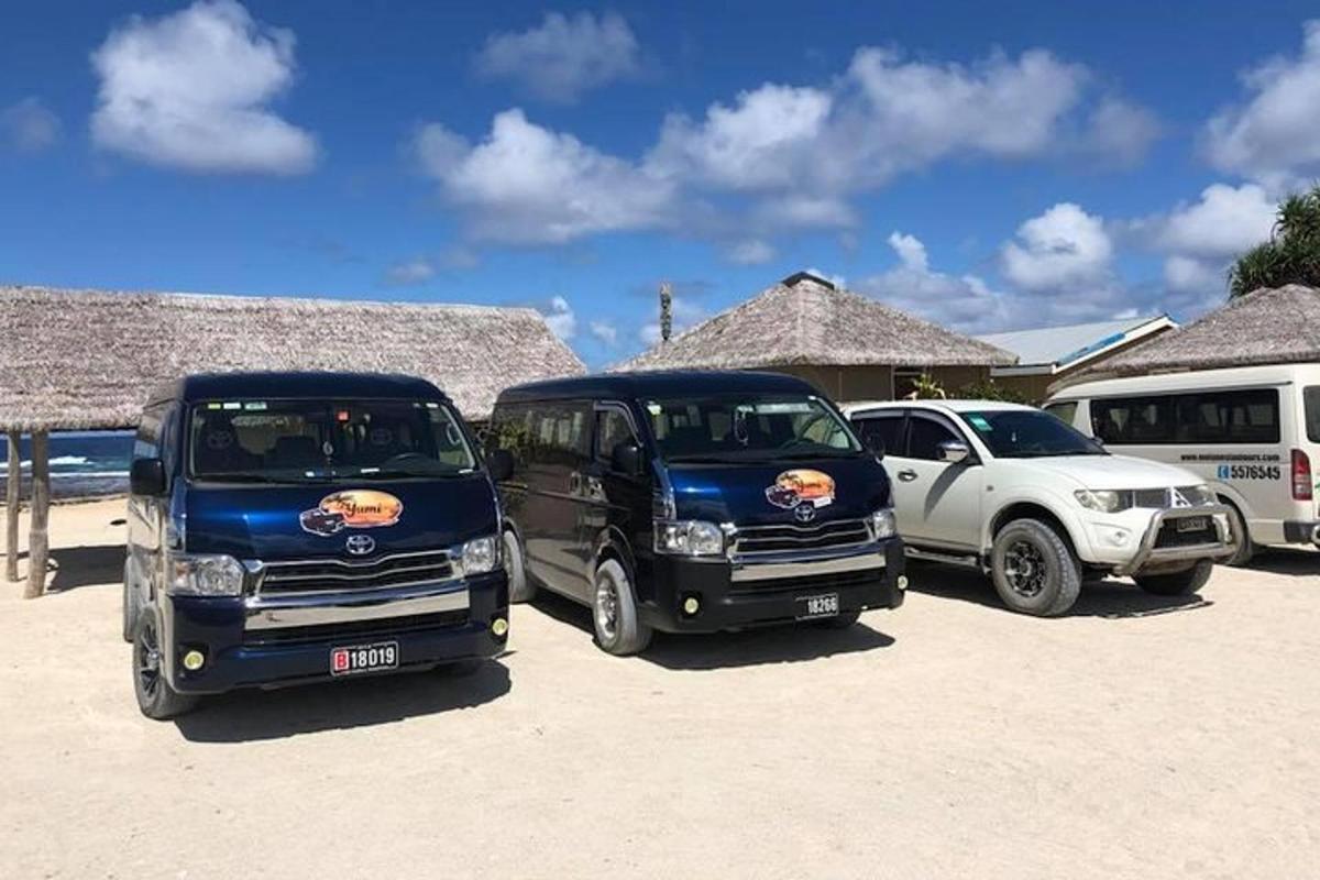 a group of three trucks parked in a parking lot