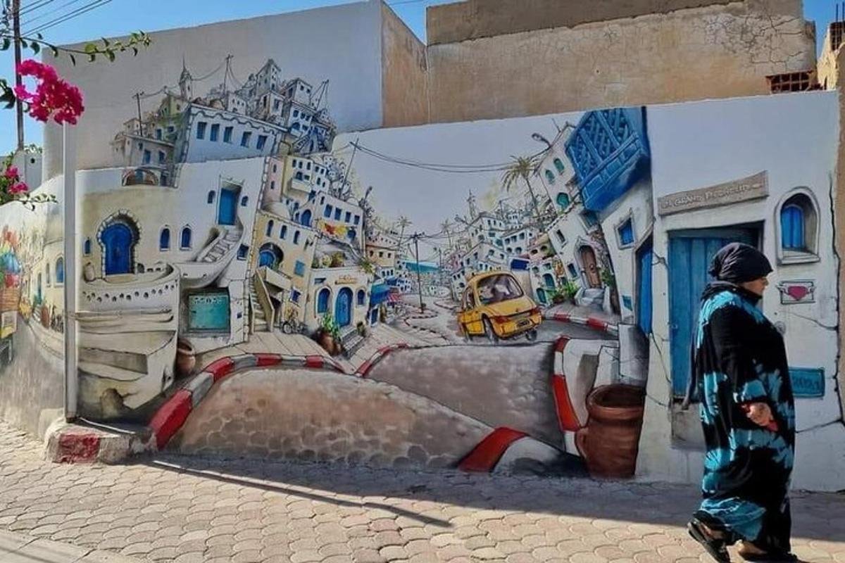 a person walking past a mural of a city