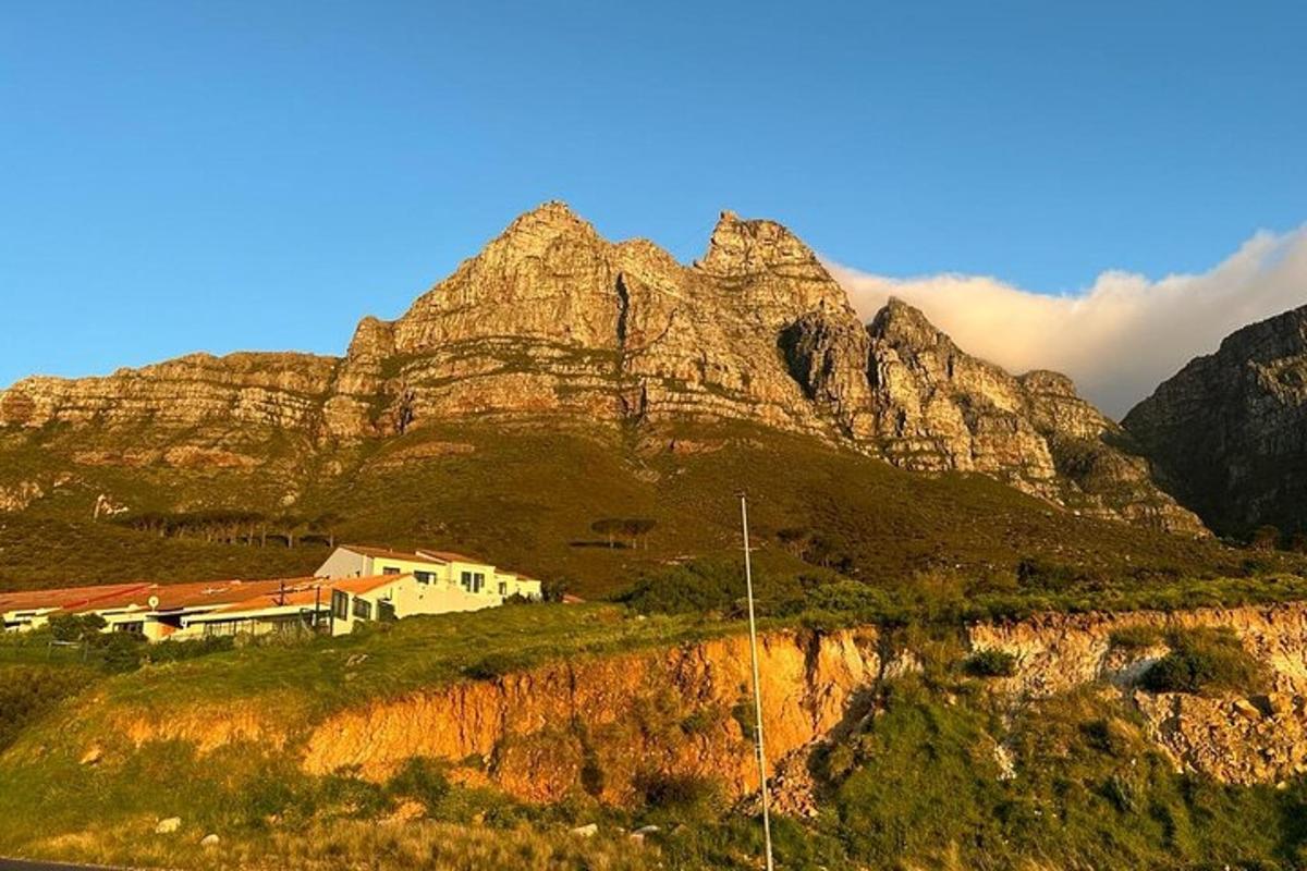 a house on a hill with a mountain