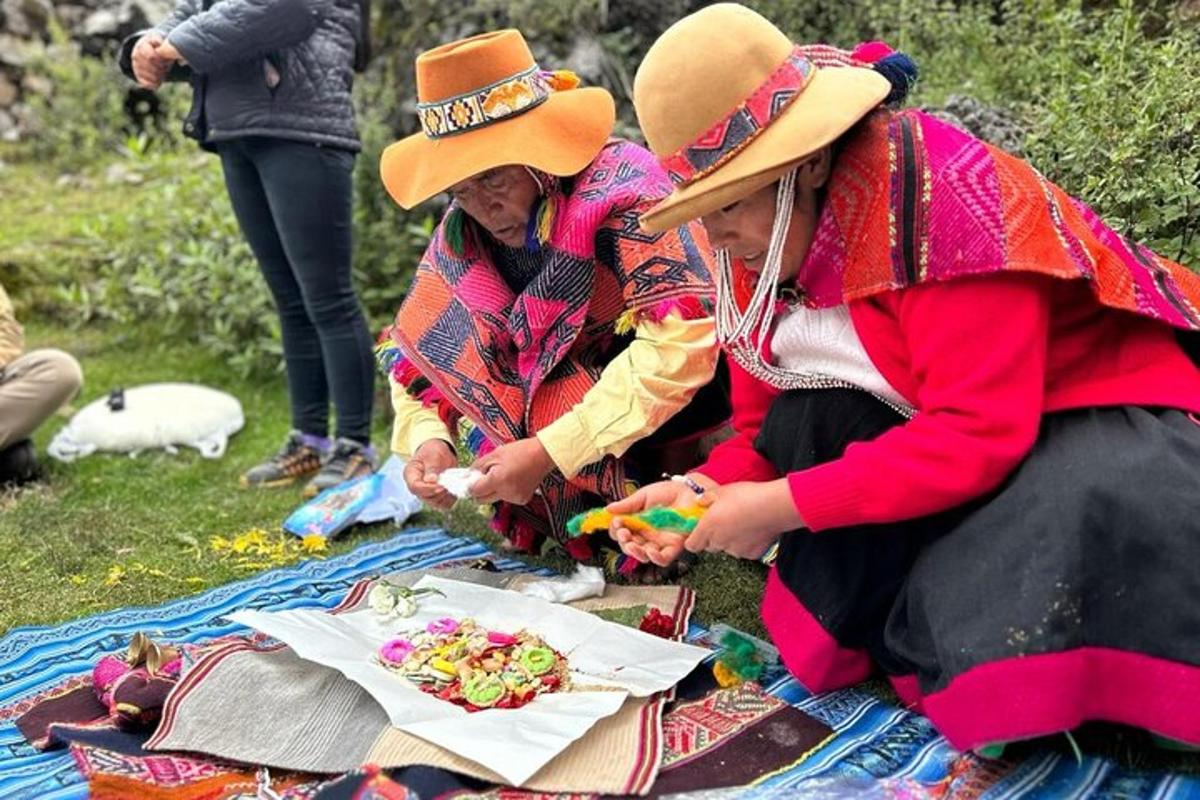 two women are sitting on a picnic blanket