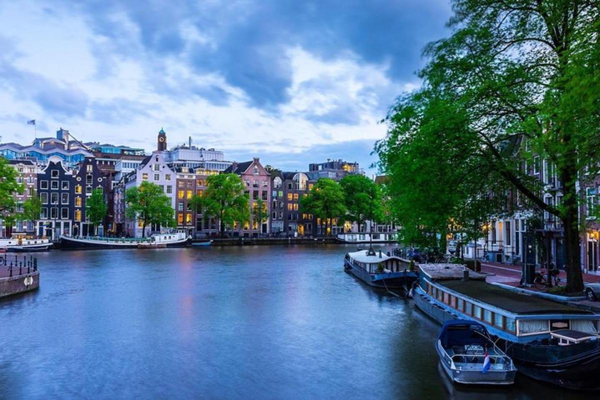 a river with boats in a city with buildings