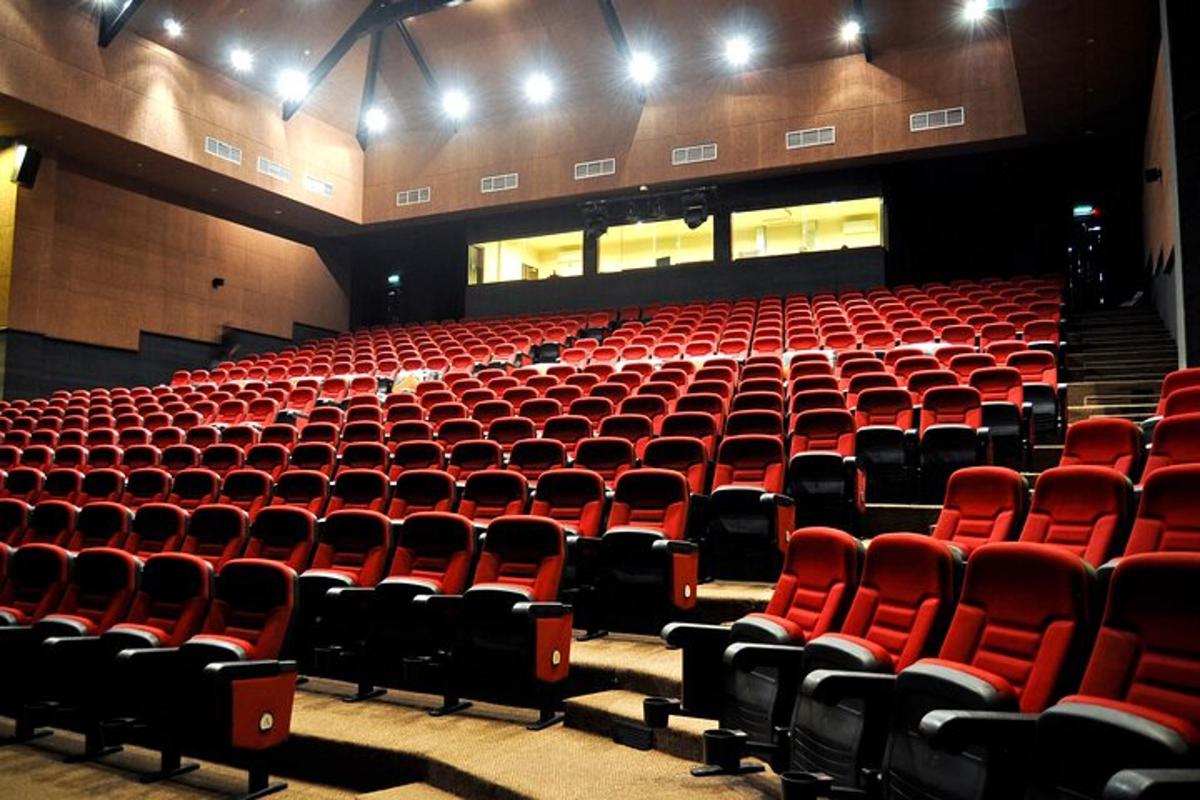 an empty auditorium with red seats in a theatre