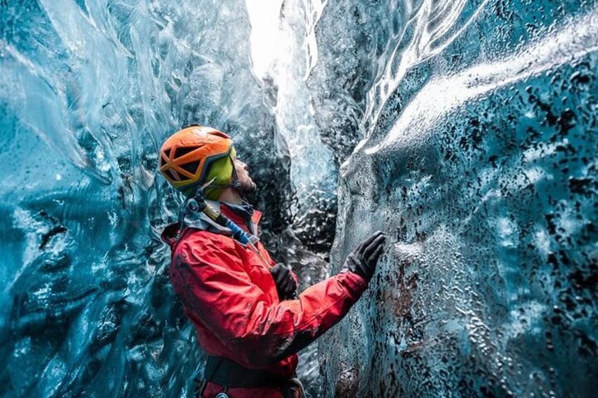 a man is standing in front of a ice cave