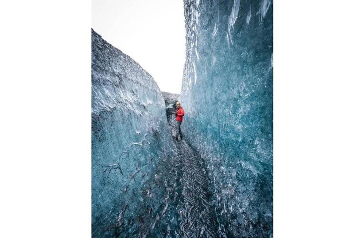 a person standing in the middle of a ice cave