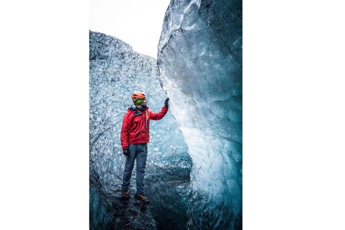 a person standing on a rock next to a glacier