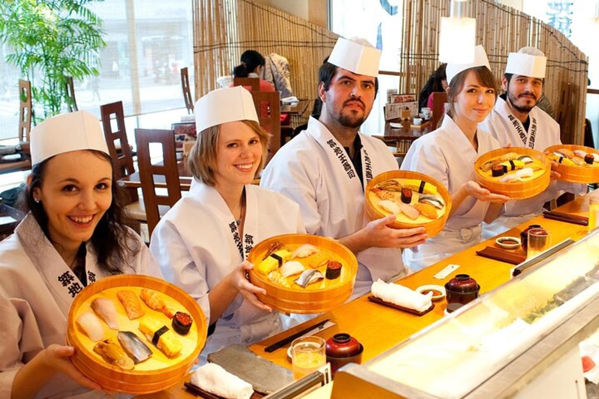 a group of chefs holding up baskets of food