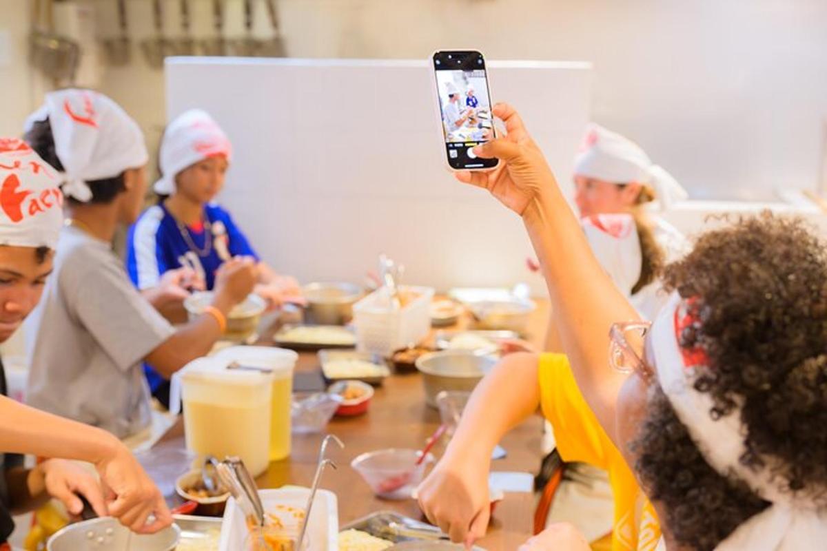 a group of people sitting around a table taking a picture