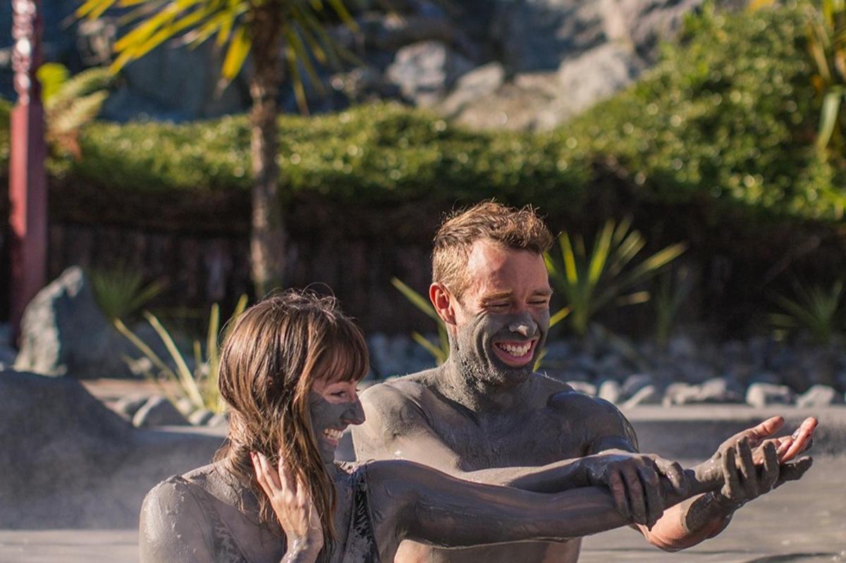 a man and a woman are playing in the mud
