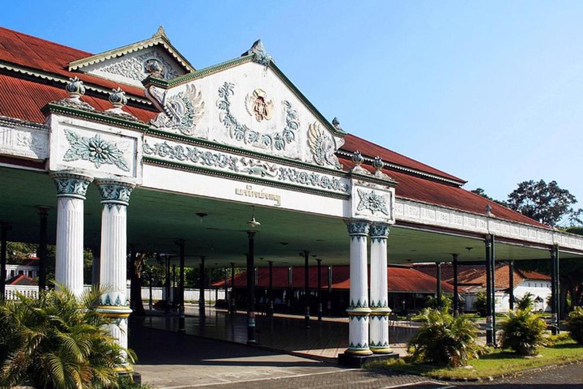 a large building with columns and a red roof