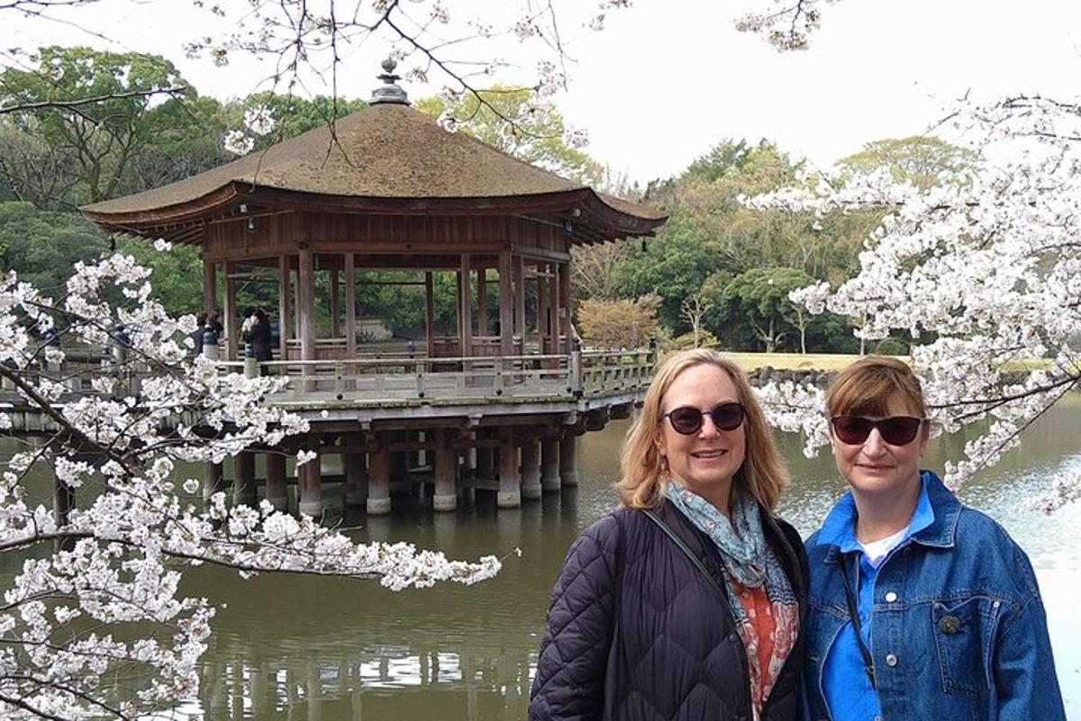 a man and a woman standing in front of a gazebo