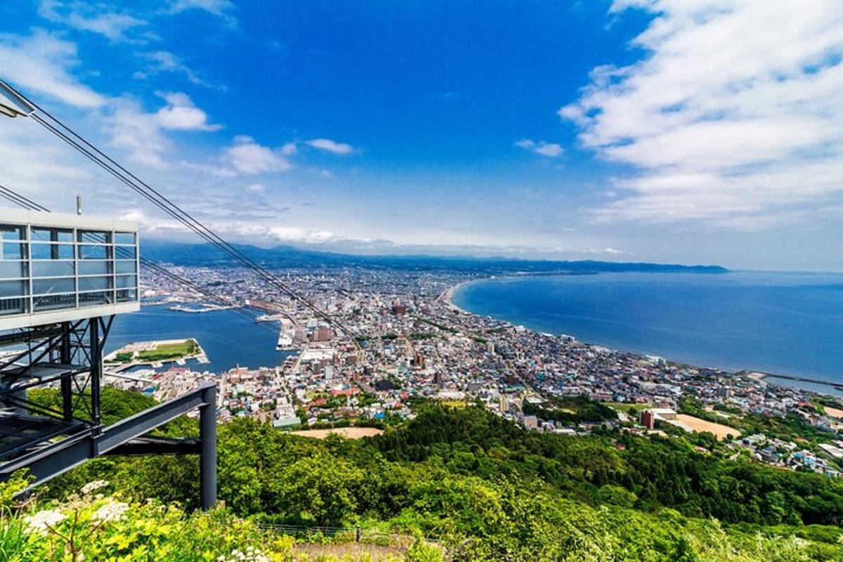 a view of a city and the ocean from a cable car