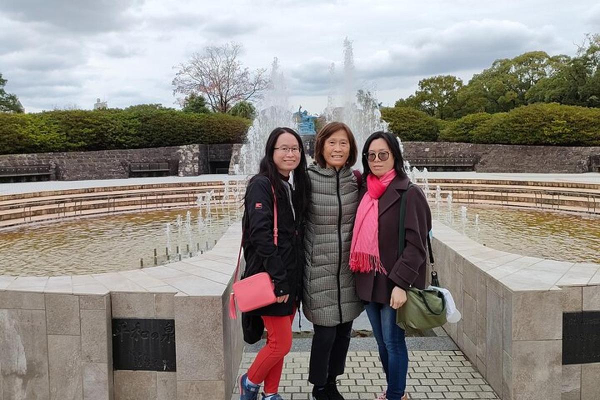 three women standing in front of a fountain