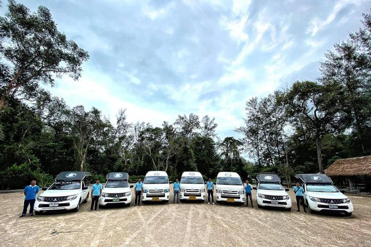 a group of white cars parked in a row