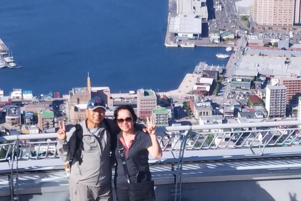 a man and a woman standing on top of a city