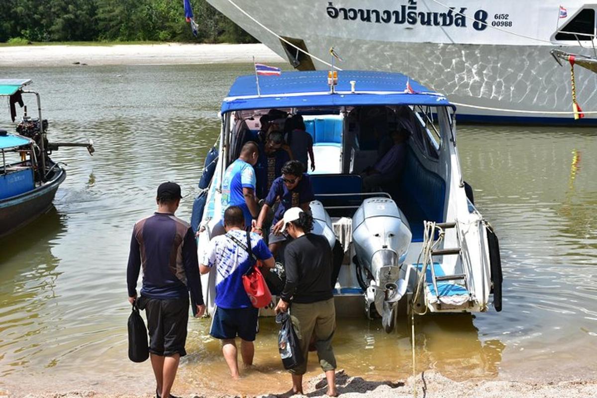 a group of people getting off a boat in the water