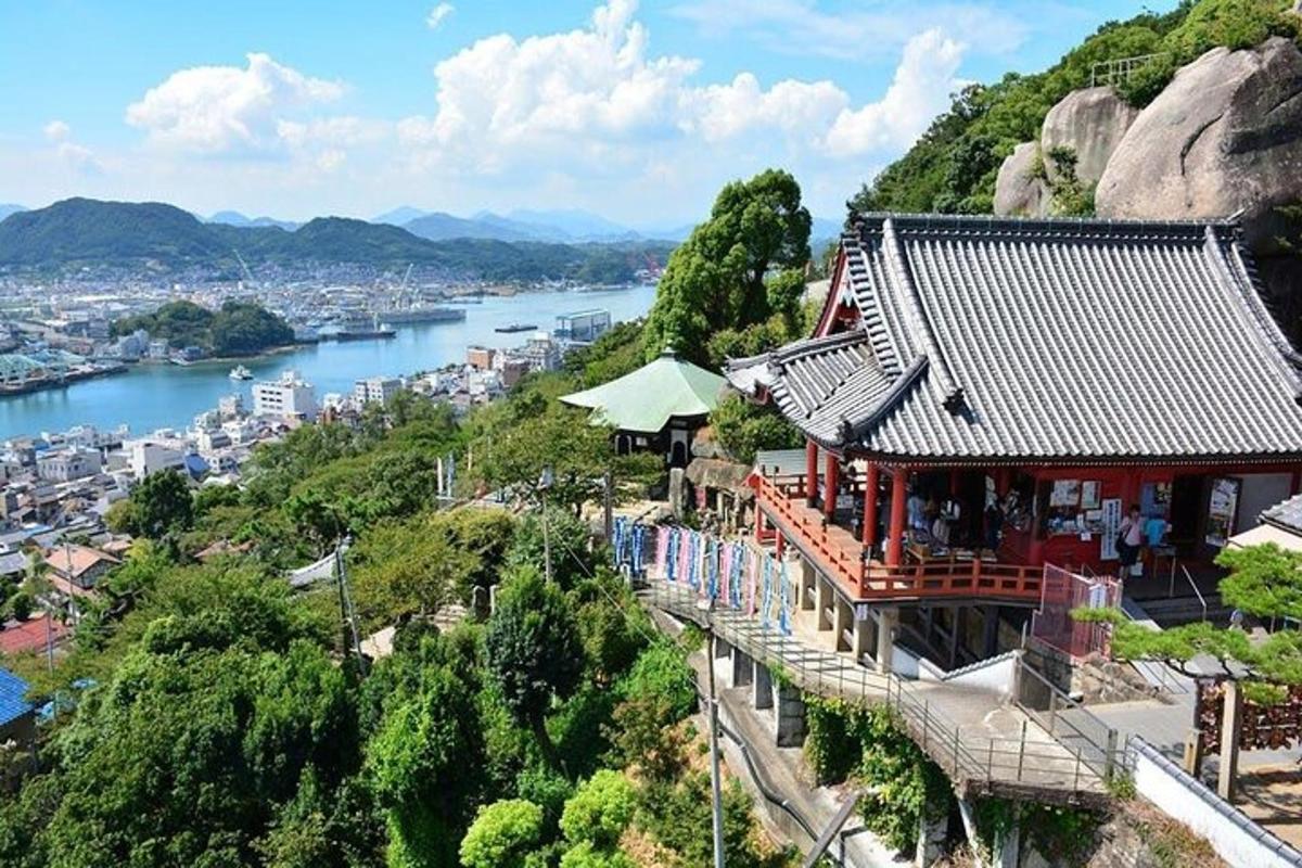 a building on a hill next to a river