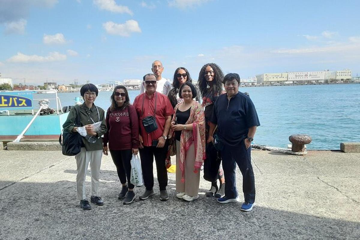 a group of people posing for a picture by the water