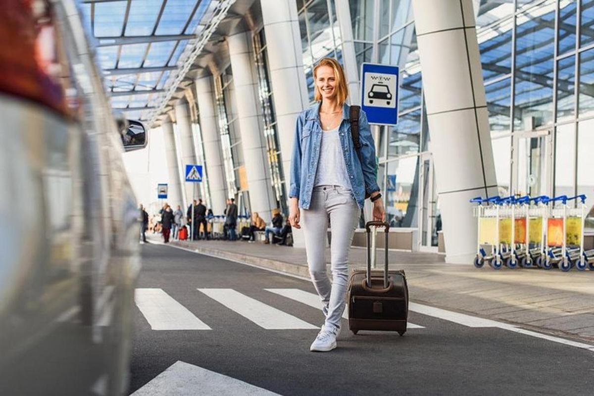 a woman walking with a suitcase in an airport