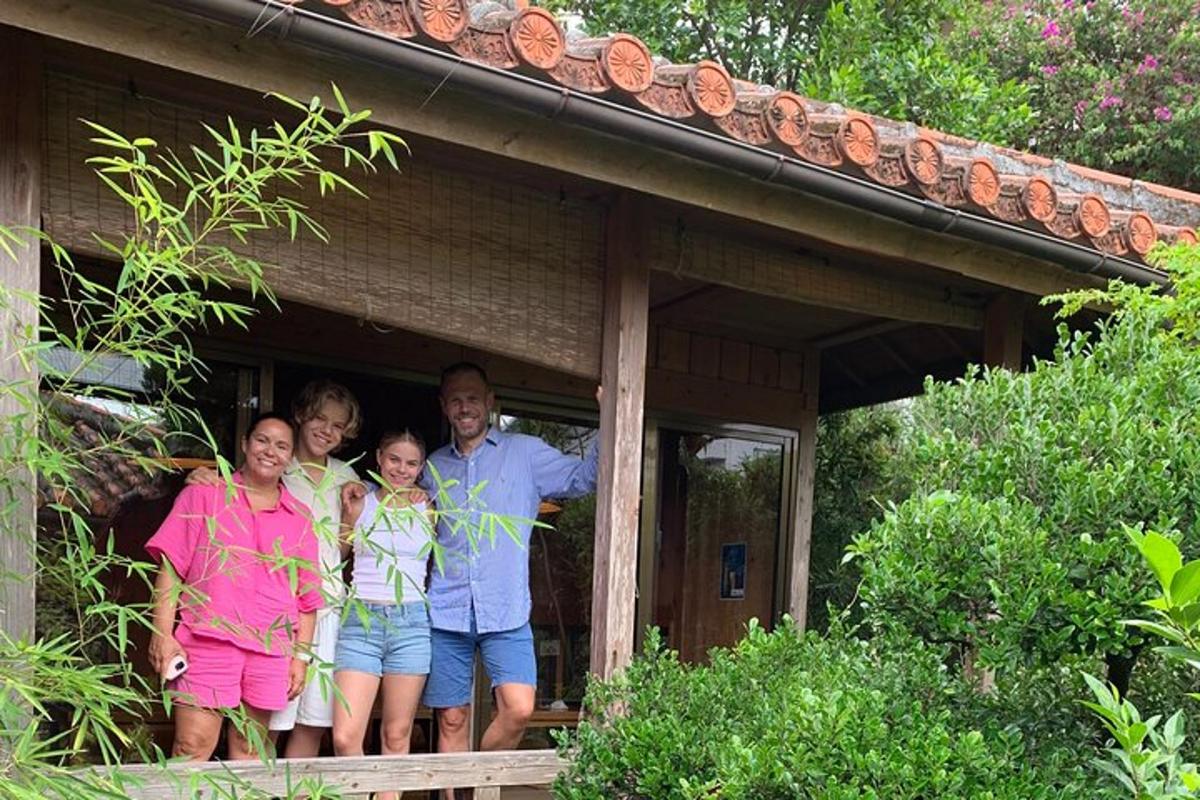 a family standing on the porch of a house