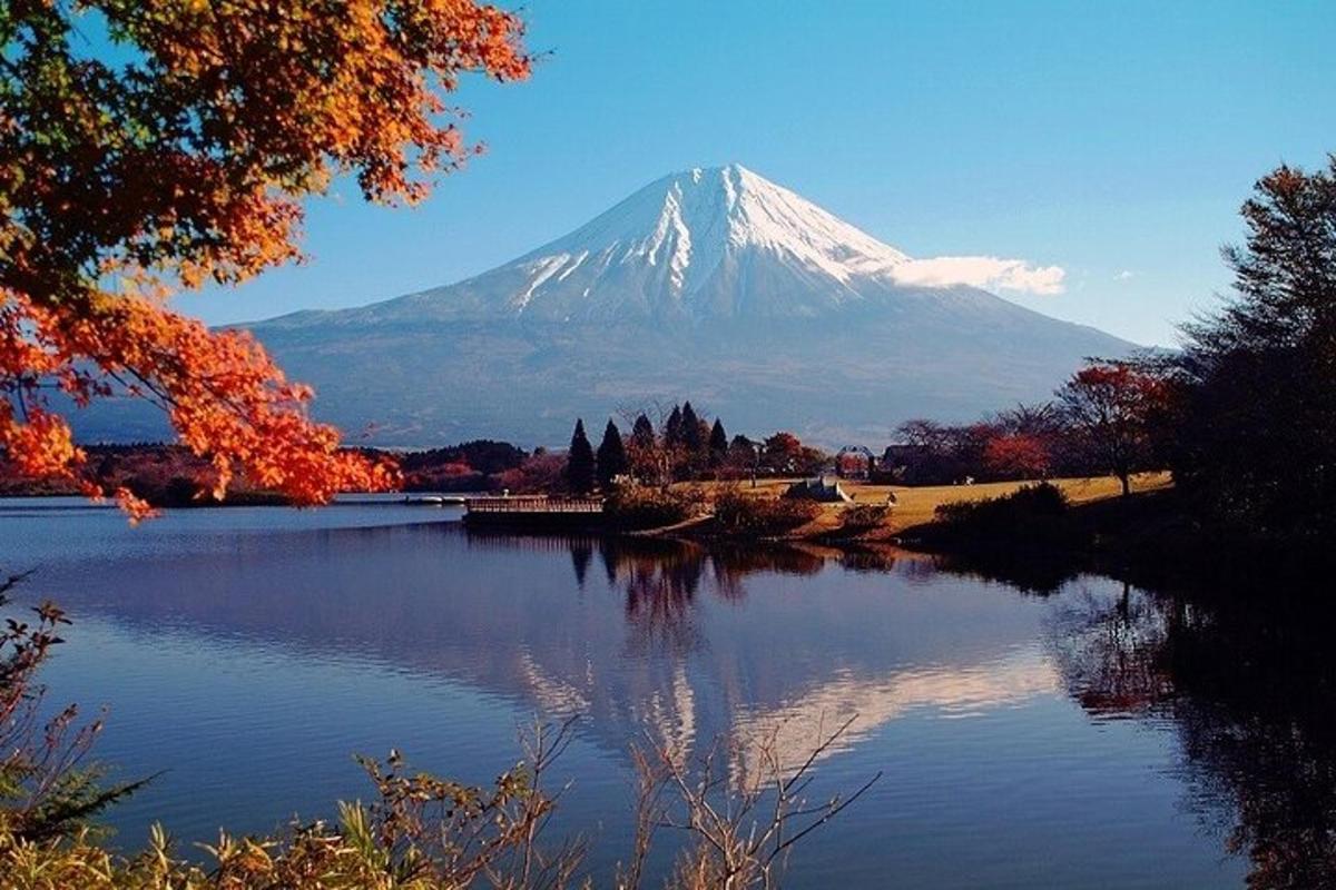 a snow covered mountain with a lake in front of it