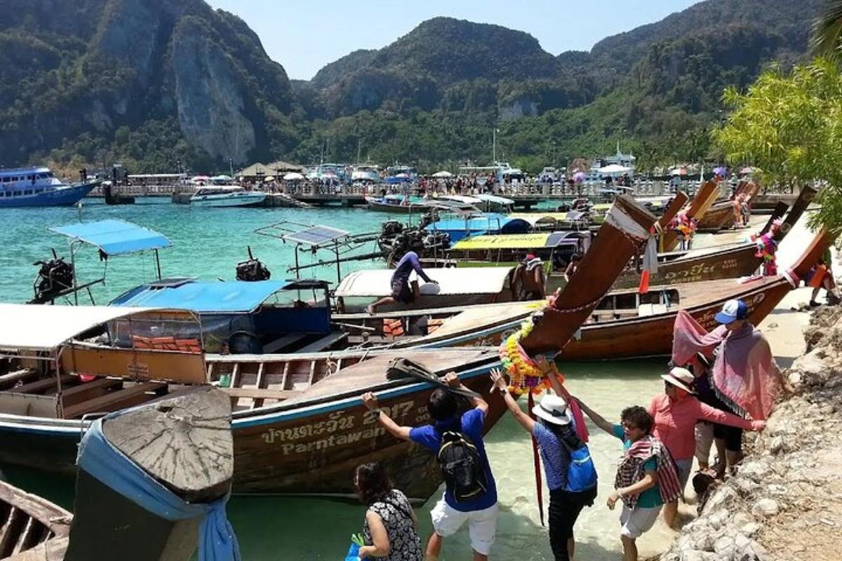 a group of people getting on boats in the water