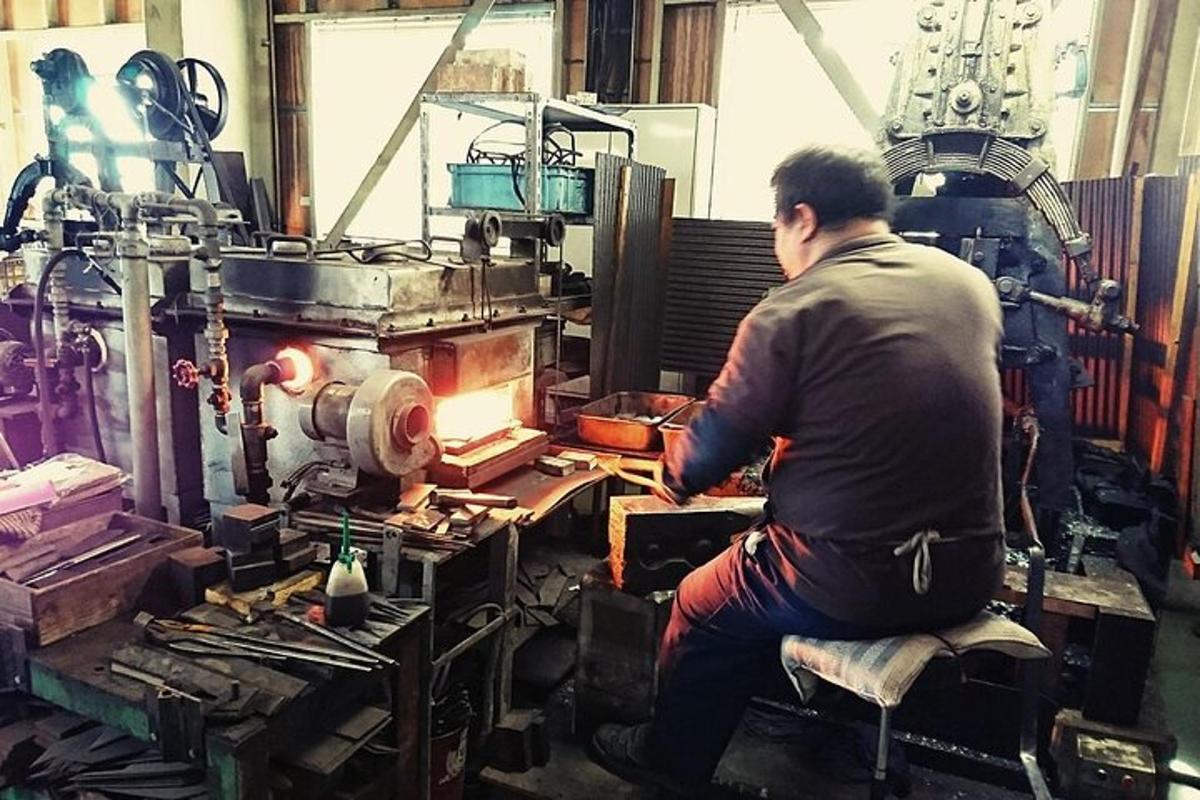 a man sitting on a chair in a workshop