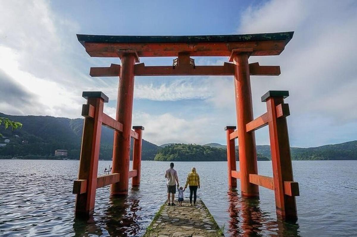 two people walking on a pier in the water
