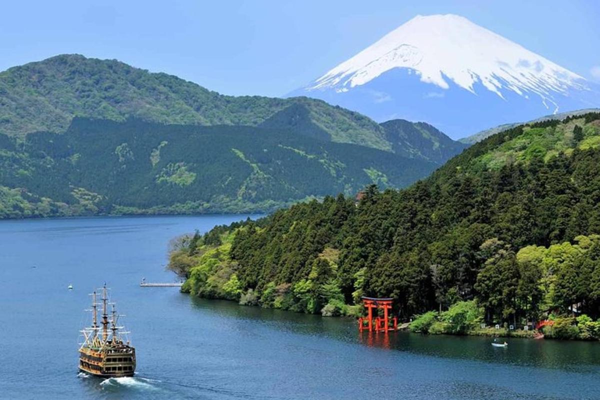 a boat in a river with a mountain in the background