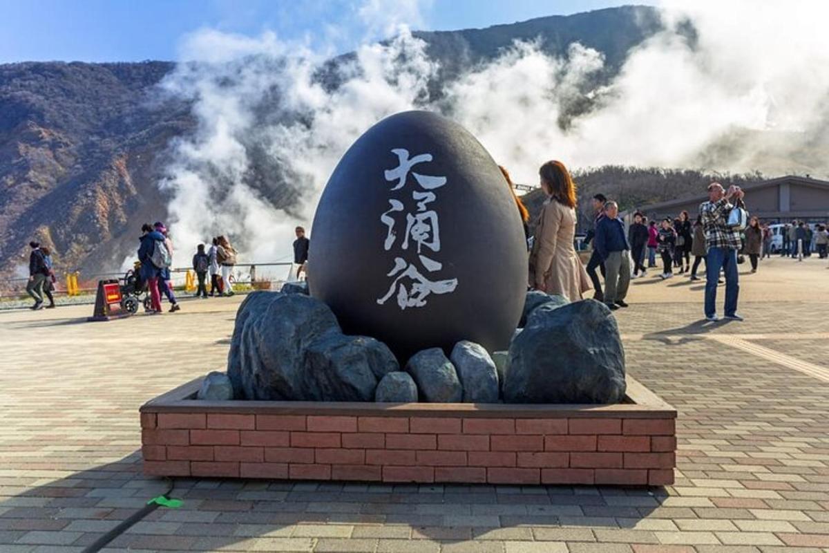 a statue of an egg sitting on top of rocks
