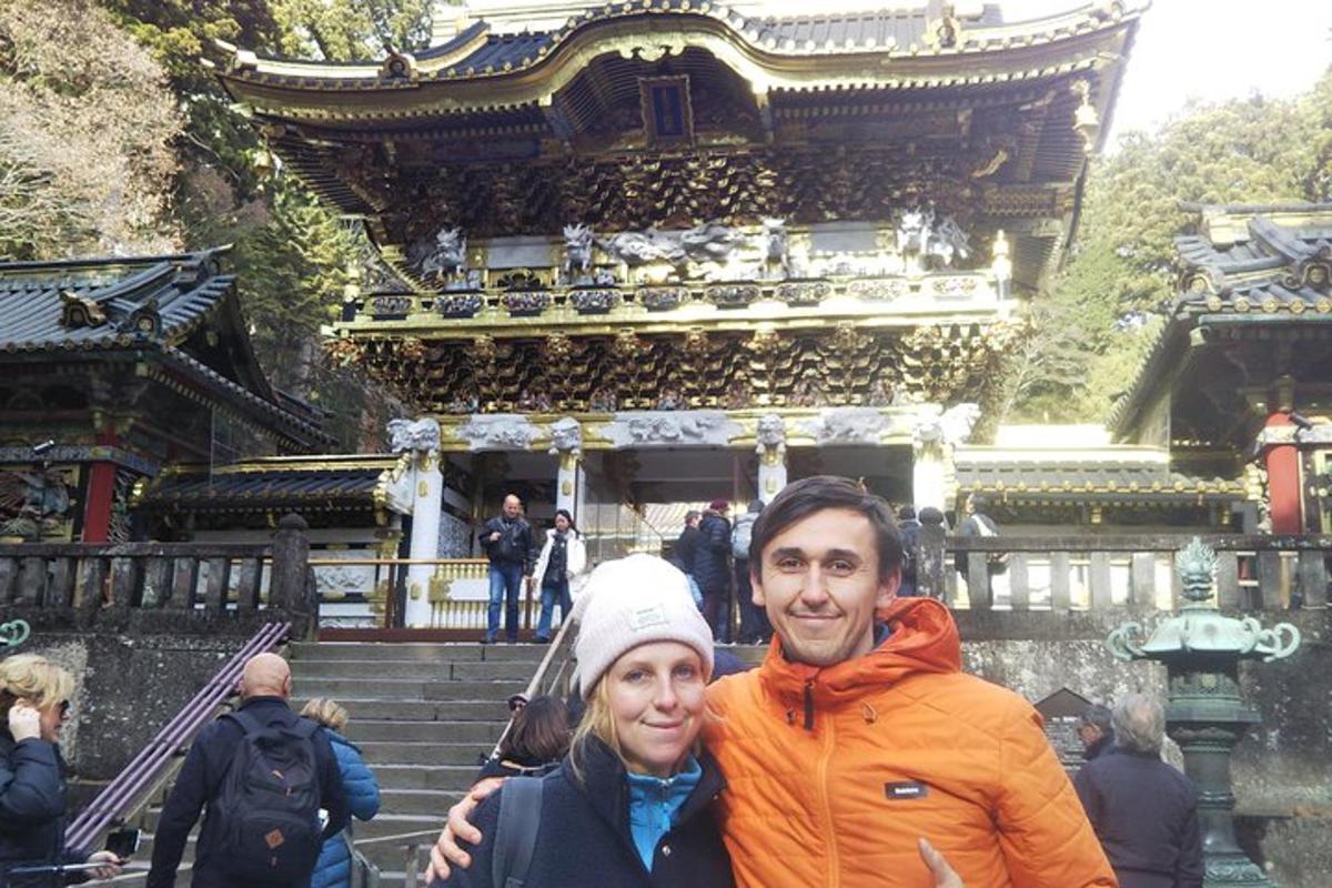 a man and a woman standing in front of a building