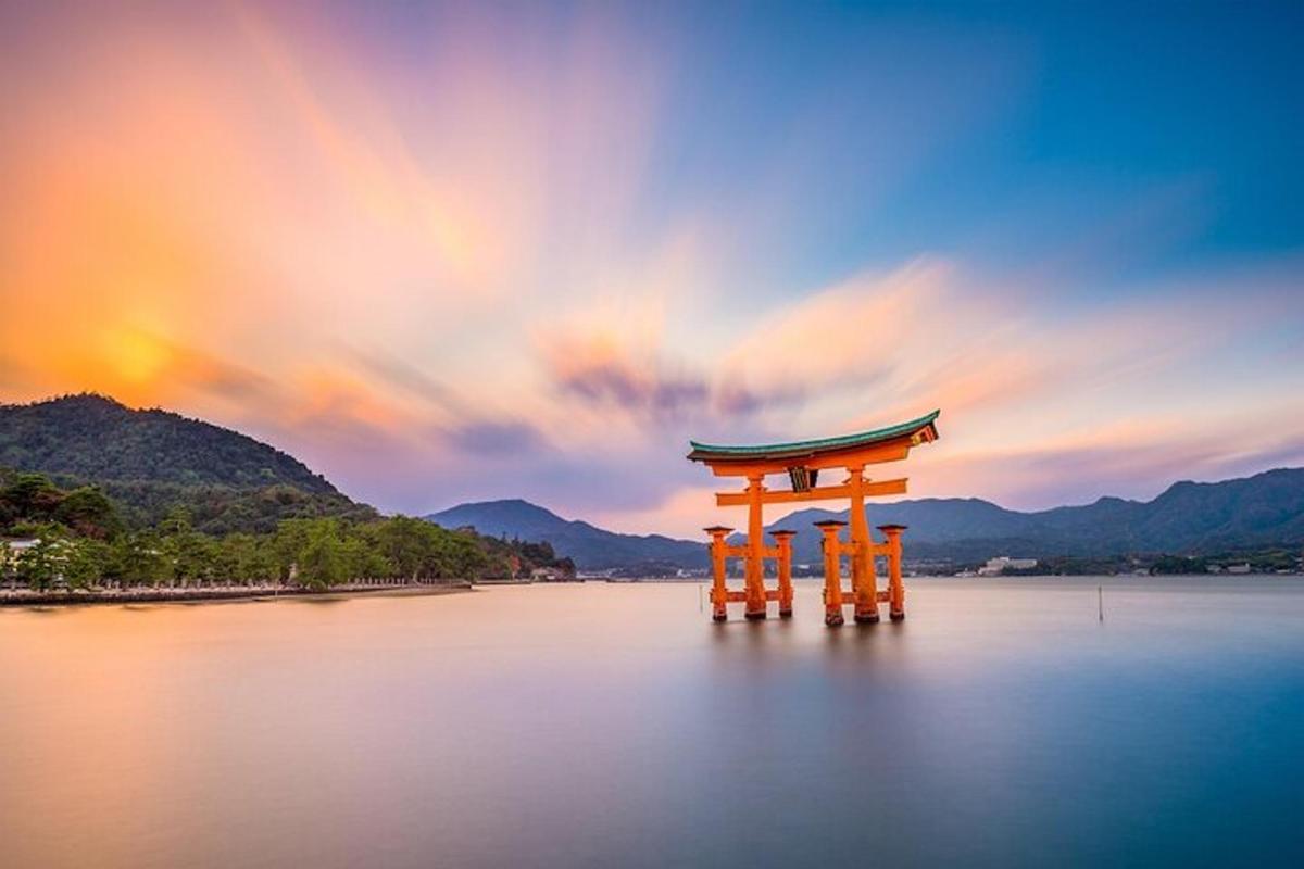 an orange torii gate in the middle of the water